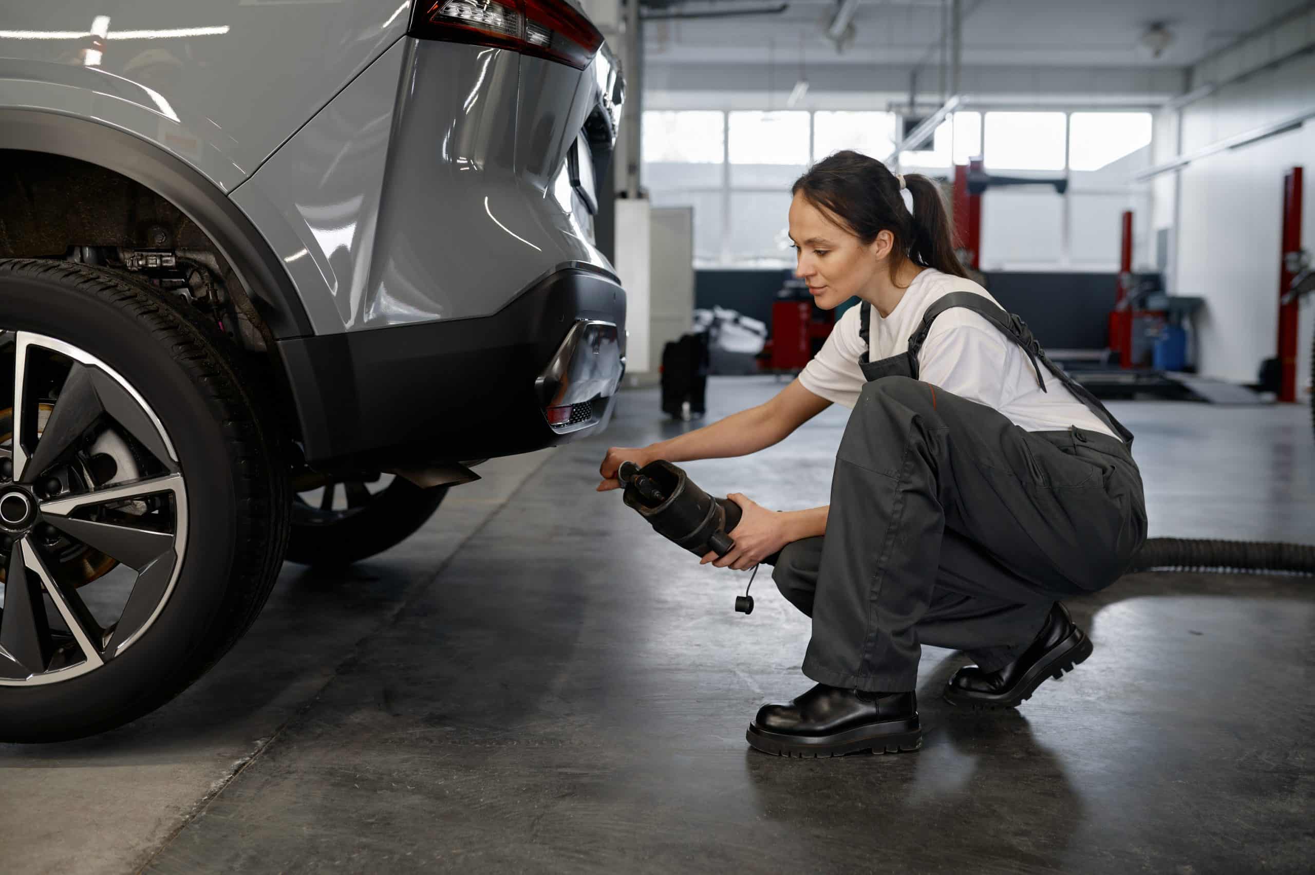 Woman mechanic testing car traffic fumes emission